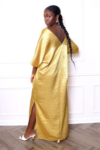 Woman wearing a gold caftan dress