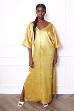 Load image into Gallery viewer, Woman wearing a gold caftan dress
